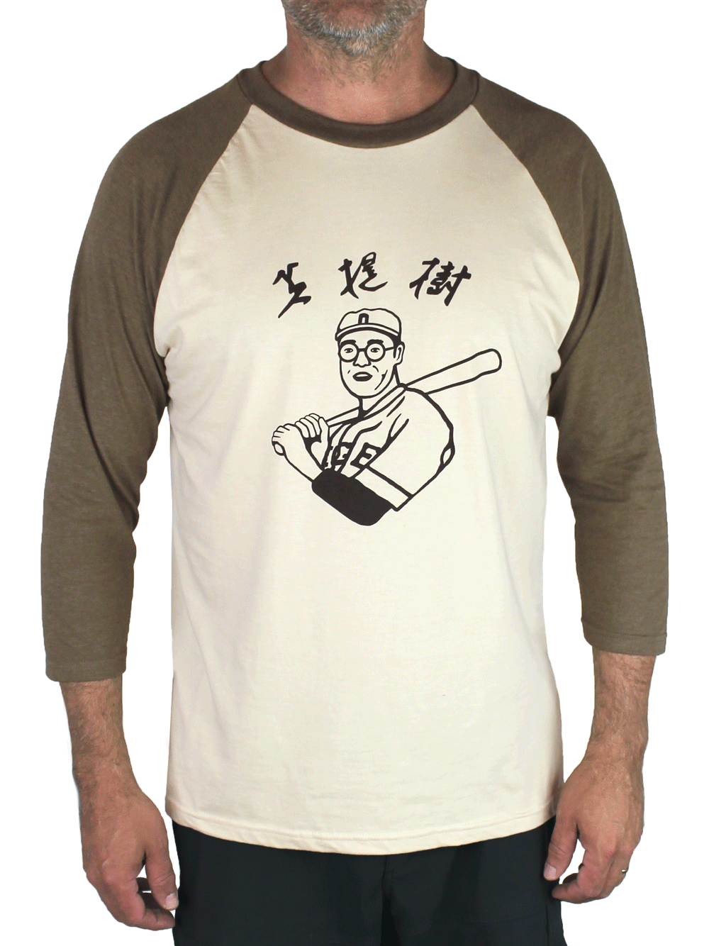 Kaoru Betto baseball shirt with olive heather raglan sleeves, a beige body, and a black screenprint of a japanese baseball player